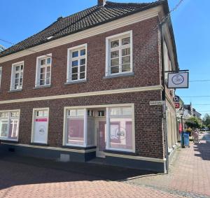 a brick building with a clock on the side of it at Sunny Side Straelen, 110 qm in Straelen