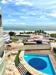 a view of a swimming pool and the beach at (106) Exclusivo Vista mar na praia da Litorânea in Pimenta