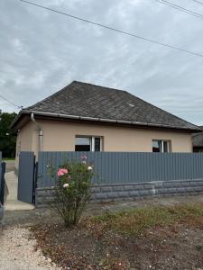a house with a fence in front of it at Széchenyi vendégház in Sajószöged
