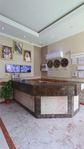 a lobby with a large stone counter in a room at Noor Manazil in Makkah