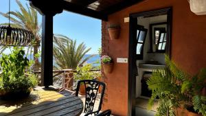 a porch with a chair and a view of the ocean at Casa Moni con Vistas al Mar in Playa de Santiago