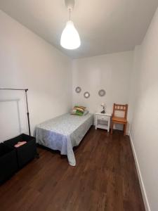 a bedroom with a bed and a table with a chair at CASA DOMINGO 2 in La Santa