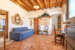 a living room with a blue couch and chairs at Cascina Ca' Storta - 15 minute to Venice in Martellago