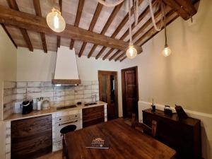 a kitchen with a wooden table in a room at Terre di Cornossa in Marta