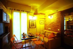 a living room with a couch and a table with chairs at Ponte Vecchio - Guicciardini n. 10 in Florence