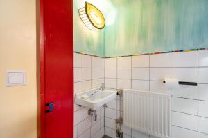 a bathroom with a sink and a light on the ceiling at Ferienwohnung Kaleidoskope in Buhlenberg