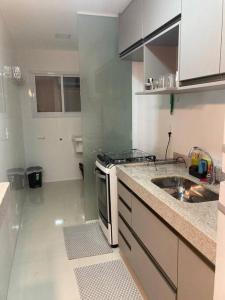 a small kitchen with a sink and a stove at Meu cantinho nas Montanhas in Domingos Martins +6 photos