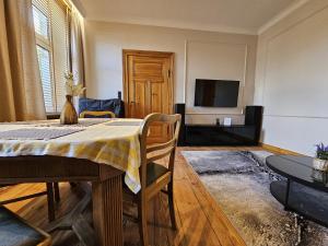 a living room with a table and a tv at Pałucki in Barcin