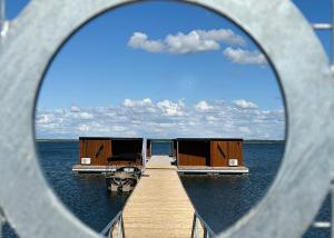 a view of a dock with houses on the water at Grand Holm Marina Ujuvmajad in Haapsalu