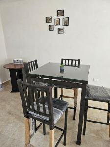 a black dining room table with two chairs and a table at Residencial Tamayo in Ocotlán