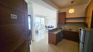a large kitchen with a view of the ocean at Paradise Palms Seaview Apartment in Larnaka +10 photos