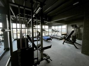 a gym with several treadmills and helicopters in it at Studio 307 in Marília