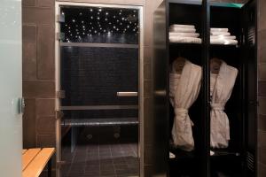 a walk in shower with a glass door in a bathroom at Hôtel Fabric in Paris +110 photos