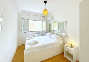Habitación blanca pequeña con cama y espejo en Solemar Sicilia - Casa Minerva, en Santa Flavia 2 fotos más