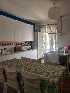 a kitchen with a table and some chairs and a kitchen with a table at Appartamento Belvedere Roccascalegna in Roccascalegna +3 photos