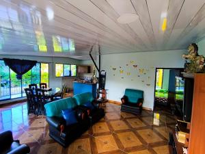 a living room with a couch and a dining room at Finca en Vergara "Prado Alto" in Vergara