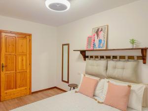 a bedroom with a bed with pink and white pillows at Gio' Garden in Gabicce Mare