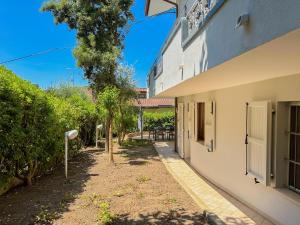 a side view of a building with trees and a pathway at Gio' Garden in Gabicce Mare