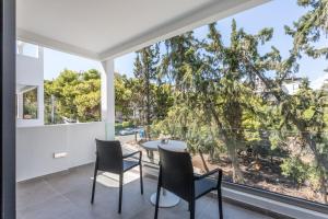 a dining room with a table and chairs and a large window at Azur Hotel in Athens