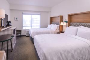 a hotel room with two beds and a window at Holiday Inn Detroit Northwest - Livonia by IHG in Livonia