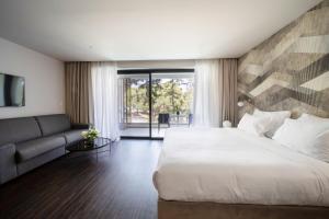 a bedroom with a large bed and a couch at Azur Hotel in Athens