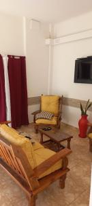 a living room with two chairs and a couch at Departamentos por dia EL TREBOL in Paso de los Libres