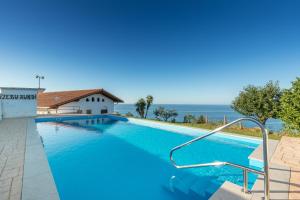 a swimming pool with a view of the ocean at Zeruhaundi - baskeyrentals in Mendexa