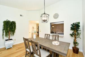 a dining room with a wooden table and chairs at Villa Pine Tree Pool close to the beaches Siesta Key in Sarasota +25 photos