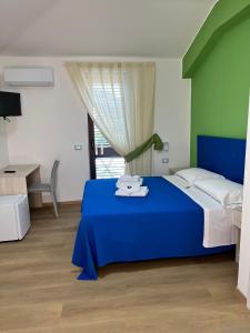 Postel nebo postele na pokoji v ubytování La Terrazza degli Dei