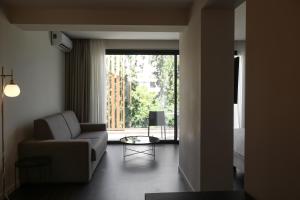 a living room with a couch and a table at Azur Hotel in Athens
