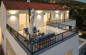 a balcony with two chairs and an umbrella at Pet Friendly Home In Sibenik in Šibenik +29 photos