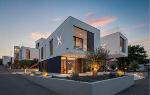 a large white building with a sunset in the background at 1 Bedroom Nice Apartment In Betina in Betina