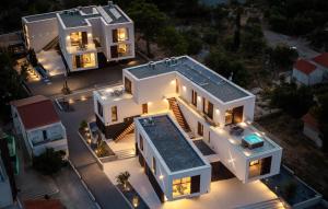 an aerial view of a large white house at night at 1 Bedroom Nice Apartment In Betina in Betina