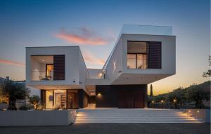 a house with a sunset in the background at 1 Bedroom Nice Apartment In Betina in Betina +13 photos