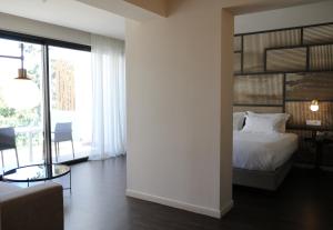 a bedroom with a bed and a large window at Azur Hotel in Athens