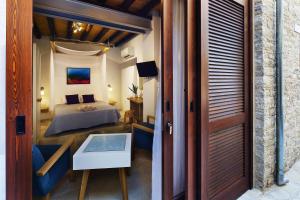 
a bedroom with a bed and a door at Palatakia - Adults Only in Kato Drys
