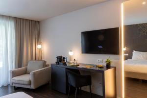 a hotel room with a desk and a bed at Azur Hotel in Athens