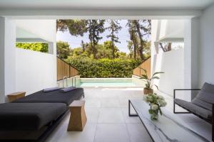 a bedroom with two beds and a pool at Azur Hotel in Athens