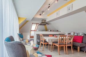 a dining room with a table and chairs at Villa Viktoria Whg 20 - "Ostseeloft" in Kölpinsee