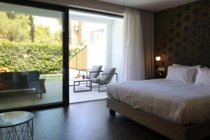 a bedroom with a bed and a sliding glass door at Azur Hotel in Athens