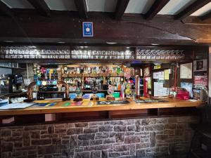 a bar in a pub with a brick wall at The Buck in Richmond