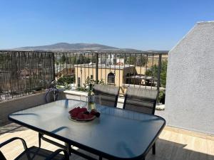 a table with a bowl of fruit on a balcony at מול הגלבוע Escape Suite in Gid‘ona