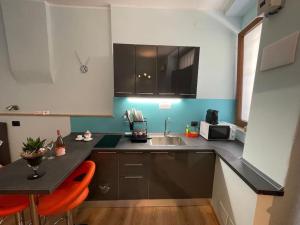 a kitchen with a black counter and a sink at Perugia Home Apartment I Mille in Perugia