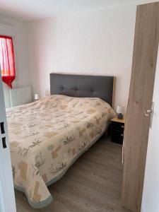 a bedroom with a bed with a blanket on it at Cool Montagne in Briançon