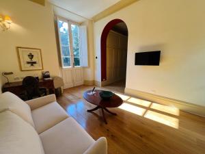 a living room with a white couch and a table at Hotel Villa Casanova in Lucca