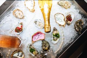a tray of oysters with ice on a table at Boutique hotel van Ham in Breda
