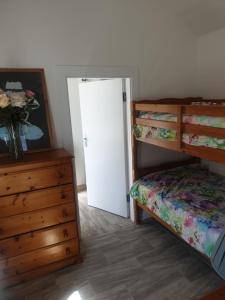 a bedroom with two bunk beds and a white door at Kays Cottage in Galway