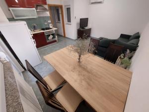 a living room with a wooden table and chairs at Tina in Kolan