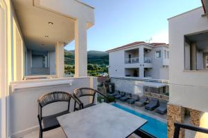 a balcony of a house with a table and chairs at Metsikas Residence in Limenas
