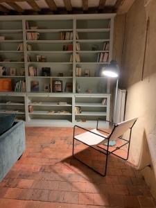 a room with a bench in front of a book shelf at La Breteche du Perche in Saint-Germain-de-la-Coudre